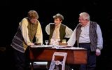 Douggie McMeekin, Samuel Blenkin and Simon Russell Beale are stood around a harpsicord studying papers. They're all in white linen shirts with waistcoats on top.