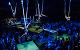 Performers twist themselves in silks high above the stage and audience