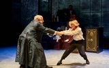 Simon Russell Beale and Lyndsey Marshal hold both hands and spin around in circle with childlike grins.