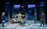 Left to right, Clare Higgins, Ony Uhiara, Sebastian De Souza, Lia Williams. Ony stands centre stage in a long green coat over a patterened pink dress, she speaks with her hands and the others stand and watch her intently.