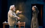 Simon Russell Beale and Lia Williams stand talking, Simon points enthusiastically and Lia laughs with her hands on her head.