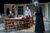 Sthbry-057 Phoebe Nicholls stands and leans on a table talking to Alex Jennings wearing a black robe. She wears a grey cardigan and long skirt. Jack Greenlees sits at the table watching the exchange.