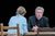 Sthbry-082 Alex Jennings sits at a table, he wears a black blazer and looks at Phoebe Nicholls