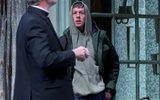 Josh Finan stands with his hands in his pockets and hood up. Alex Jennings looks down his nose at him.