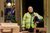 Sthbry-205 Holly Atkins stands in a doorway wearing a high vis jacket and carrying a motorbike helmet.